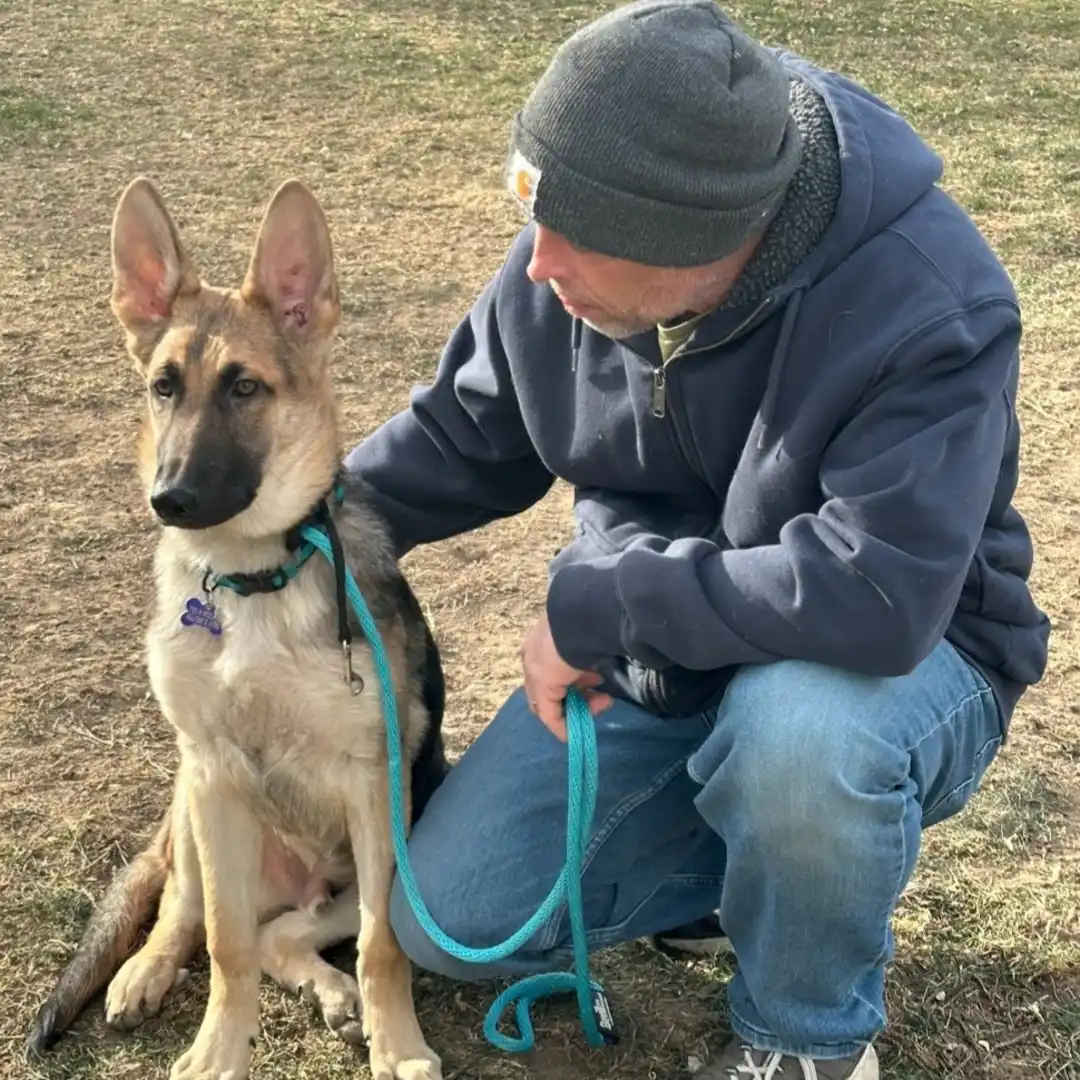 Steve the Dogman petting a puppy