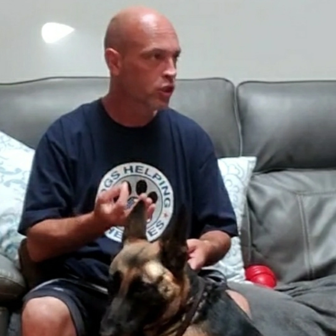 Steve the Dogman sitting on a couch with a german shepherd